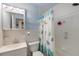 Well-lit bathroom with a shower-tub combination and a decorative shower curtain at 4932 Murray Hill Dr, Tampa, FL 33615