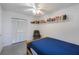 Bedroom with a white ceiling fan and shelves with books at 4932 Murray Hill Dr, Tampa, FL 33615