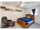 Cozy bedroom with a wooden bed frame, reading chair, and built-in bookshelf along the wall at 4932 Murray Hill Dr, Tampa, FL 33615