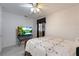 Bright bedroom with a decorative bedspread, modern TV, and a ceiling fan for added comfort at 4932 Murray Hill Dr, Tampa, FL 33615