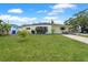 Charming single-story home featuring a spacious front yard and a concrete driveway at 4932 Murray Hill Dr, Tampa, FL 33615