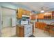 Kitchen with oak cabinets, tile backsplash, white appliances and bar stool seating at 4932 Murray Hill Dr, Tampa, FL 33615