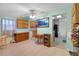 Bright and airy kitchen with classic cabinets, tile floors, and access to adjacent rooms at 4932 Murray Hill Dr, Tampa, FL 33615