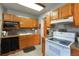 Traditional-style kitchen with oak cabinets, granite countertops, and modern appliances at 4932 Murray Hill Dr, Tampa, FL 33615