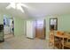 Functional eat-in kitchen features tile floors, table with chairs, and access to laundry room at 4932 Murray Hill Dr, Tampa, FL 33615