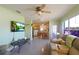 Cozy living room with a TV, leather sofa and view into the kitchen with barstool seating at 4932 Murray Hill Dr, Tampa, FL 33615