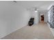 Bright, open living room features neutral tile floors, a ceiling fan, and a comfortable recliner at 4932 Murray Hill Dr, Tampa, FL 33615