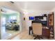 Office area with desk, chair, and view into adjacent living room at 4932 Murray Hill Dr, Tampa, FL 33615