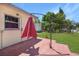 View of the back of the house with a brick patio and a large canopy umbrella at 4932 Murray Hill Dr, Tampa, FL 33615