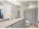 Bathroom featuring granite countertop, white cabinets, and a shower with striped curtain at 5733 Colony Glen Rd, Lithia, FL 33547