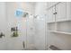 Bright bathroom featuring a frameless glass walk-in shower and storage cabinets at 5917 Cat Claw Ln, Bradenton, FL 34210