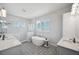 Bright bathroom boasts a standalone tub, a glass enclosed shower, and dual vanities at 5917 Cat Claw Ln, Bradenton, FL 34210