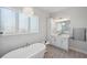 Modern bathroom with freestanding tub, white vanity, and patterned tile flooring at 5917 Cat Claw Ln, Bradenton, FL 34210