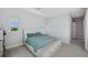 Well-lit bedroom with accent pillows, and bench seating at the foot of the bed for comfort at 5917 Cat Claw Ln, Bradenton, FL 34210