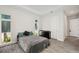 Stylish bedroom with modern windows, tile floors, dark gray comforter, and a black dresser at 5917 Cat Claw Ln, Bradenton, FL 34210