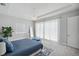 Spacious bedroom featuring soft white floors, tray ceiling, and large windows at 5917 Cat Claw Ln, Bradenton, FL 34210