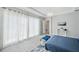 Bedroom features white flooring, a tray ceiling, and sliding glass doors at 5917 Cat Claw Ln, Bradenton, FL 34210