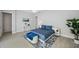 Well-lit bedroom featuring blue accents, light wood floors, and bright furniture at 5917 Cat Claw Ln, Bradenton, FL 34210