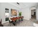 Bright dining room with wood table, modern lighting, and views to the outside at 5917 Cat Claw Ln, Bradenton, FL 34210