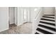 Bright entryway with dark wood stairs and a front door with sidelights at 5917 Cat Claw Ln, Bradenton, FL 34210