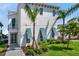 Charming two-story home with a manicured lawn, tropical landscaping, and colorful window shutters at 5917 Cat Claw Ln, Bradenton, FL 34210