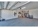 Spacious garage with epoxy flooring, storage cabinets, and a modern bike at 5917 Cat Claw Ln, Bradenton, FL 34210