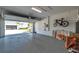 A spacious garage with epoxy flooring. and car parked outside at 5917 Cat Claw Ln, Bradenton, FL 34210