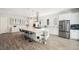 Modern kitchen featuring a large island with seating and stainless steel appliances at 5917 Cat Claw Ln, Bradenton, FL 34210