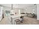 Open kitchen with stainless appliances, island seating, and seamless flow to living area at 5917 Cat Claw Ln, Bradenton, FL 34210