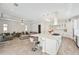 Open-concept living space with a large kitchen island, modern lighting, and a comfortable living area at 5917 Cat Claw Ln, Bradenton, FL 34210