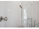 Modern shower with sleek fixtures, white tiles, a glass door, and convenient built-in shelving at 5917 Cat Claw Ln, Bradenton, FL 34210