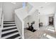 Bright room with dark wood stairs, exercise bike and wood-look flooring at 5917 Cat Claw Ln, Bradenton, FL 34210