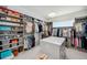 Bright walk-in closet featuring custom shelving and an island for organizing clothes at 5917 Cat Claw Ln, Bradenton, FL 34210