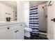 Modern bathroom with black hexagon tile floors, subway tile shower, and white vanity at 605 Bainbridge Dr, Brandon, FL 33511