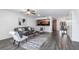 Open-concept living room featuring modern decor, wood-look flooring and a view of the kitchen at 605 Bainbridge Dr, Brandon, FL 33511