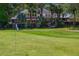 Expansive backyard with a well-manicured lawn and mature trees surrounding a beautiful home at 6352 W Maclaurin Dr, Tampa, FL 33647