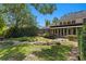 Lush backyard features a meticulously manicured lawn, stone pathway, and mature trees at 6352 W Maclaurin Dr, Tampa, FL 33647