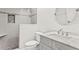 Modern bathroom featuring a walk-in shower, a single sink vanity, and neutral decor at 6352 W Maclaurin Dr, Tampa, FL 33647