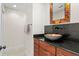 Stylish powder room with a vessel sink, decorative mirror, and modern fixtures at 6352 W Maclaurin Dr, Tampa, FL 33647