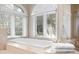 Relaxing bathtub with white trim and large windows, creating a peaceful atmosphere at 6352 W Maclaurin Dr, Tampa, FL 33647