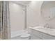 Well-lit bathroom featuring a shower-tub combo with decorative tile and single sink vanity at 6352 W Maclaurin Dr, Tampa, FL 33647