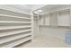 Walk-in closet with custom shelving and marble floors provide great space for organizing at 6352 W Maclaurin Dr, Tampa, FL 33647