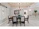 Well-lit dining room with a stylish chandelier and view into another room at 6352 W Maclaurin Dr, Tampa, FL 33647