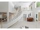 Grand foyer featuring a curved staircase, soaring ceilings, and elegant tile flooring at 6352 W Maclaurin Dr, Tampa, FL 33647