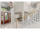 Elegant foyer boasting a staircase, marble flooring, and a chandelier at 6352 W Maclaurin Dr, Tampa, FL 33647