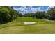 Picturesque golf course featuring lush greenery, a sand trap, and blue skies, perfect for golf enthusiasts at 6352 W Maclaurin Dr, Tampa, FL 33647