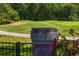 Golf course view with lush greenery and sand trap visible beyond landscaped yard at 6352 W Maclaurin Dr, Tampa, FL 33647