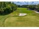 Expansive golf course view featuring lush greenery, a sand trap, and blue skies, enhancing the property's appeal at 6352 W Maclaurin Dr, Tampa, FL 33647