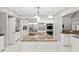 Bright kitchen with marble floors, granite countertops, stainless steel appliances and modern lighting at 6352 W Maclaurin Dr, Tampa, FL 33647