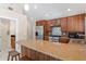 Contemporary kitchen with wood cabinets, granite countertops, and stainless steel appliances at 6352 W Maclaurin Dr, Tampa, FL 33647